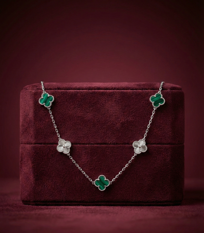 Floral necklace on a burgundy jewelry box with a dark red background