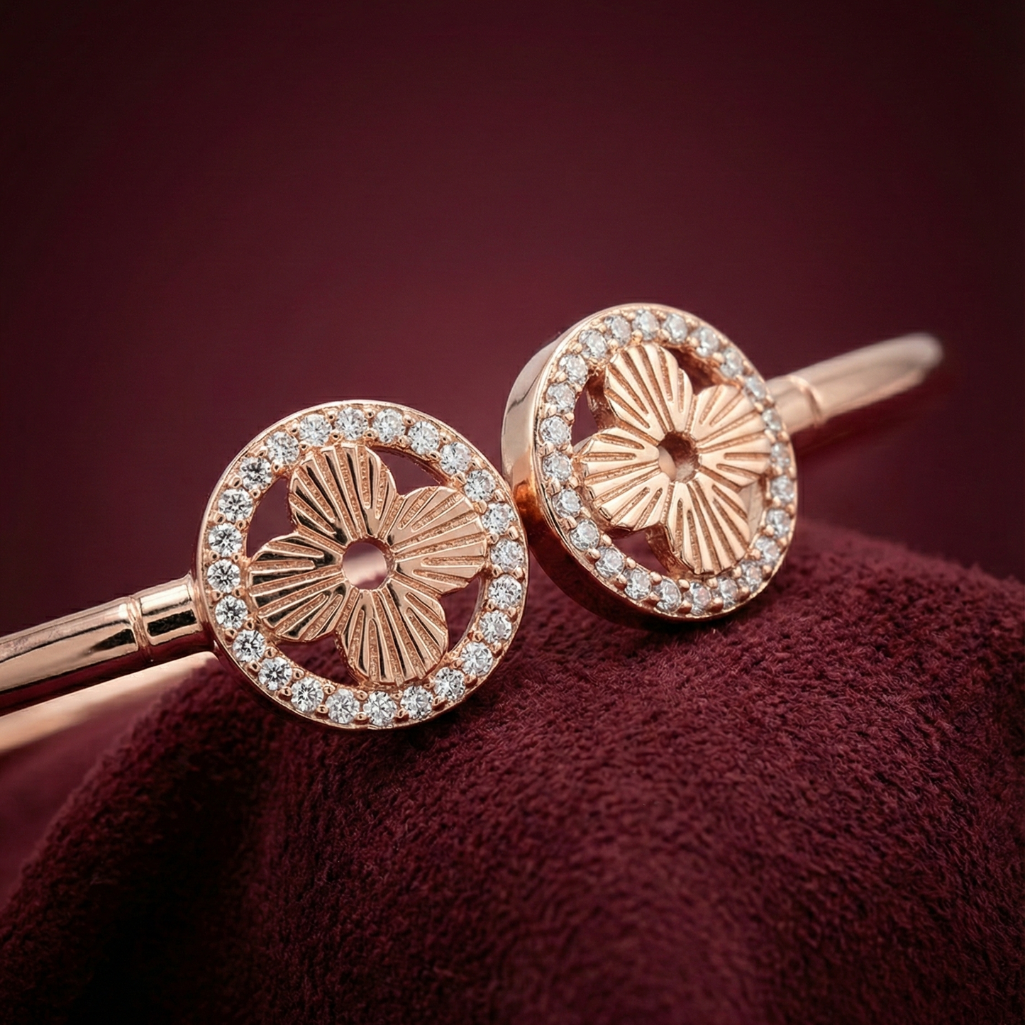 Rose gold hair pins with floral design on a maroon background