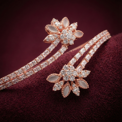 Rose gold bracelet with floral design on a dark red background