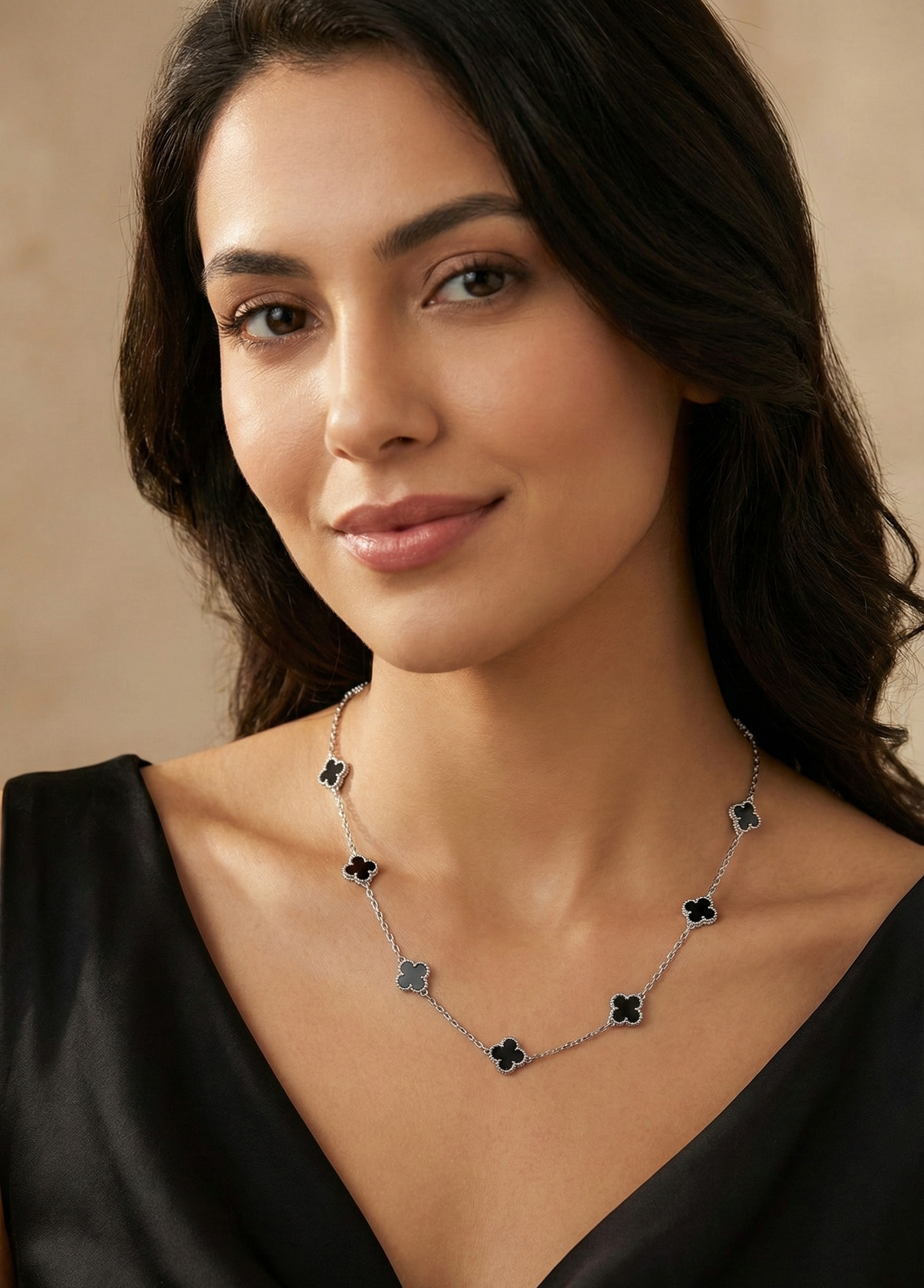 Woman wearing a necklace with a neutral background