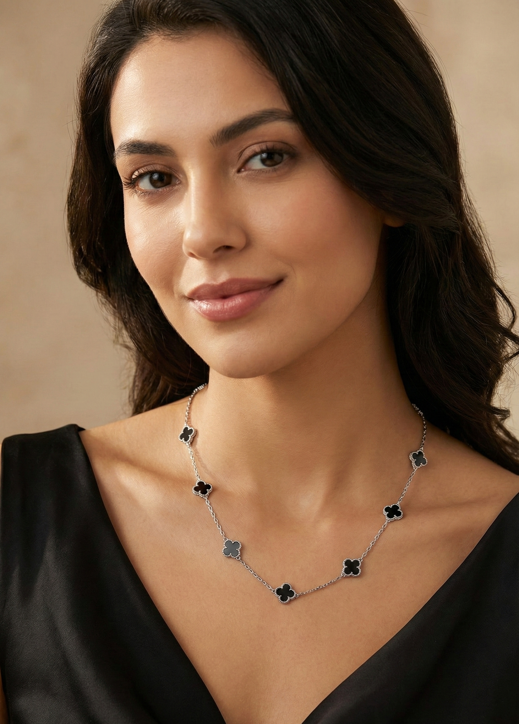 Woman wearing a necklace with a neutral background
