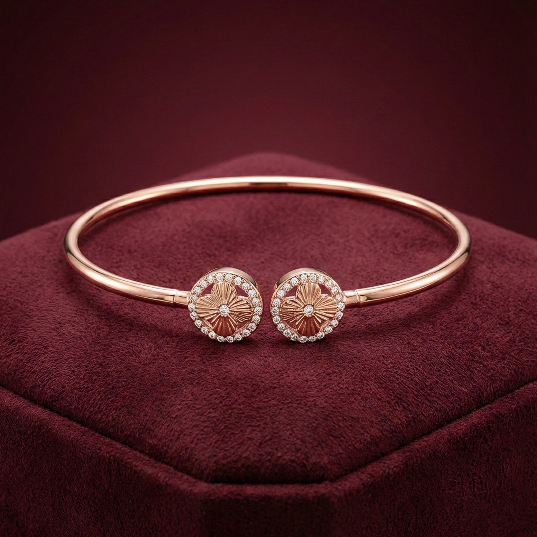 Rose gold bracelet with circular embellishments on a red cushion