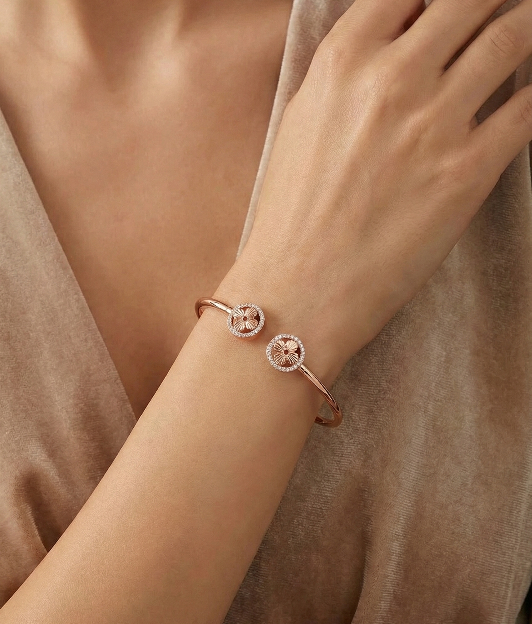 Rose gold bracelet on a wrist with a neutral background